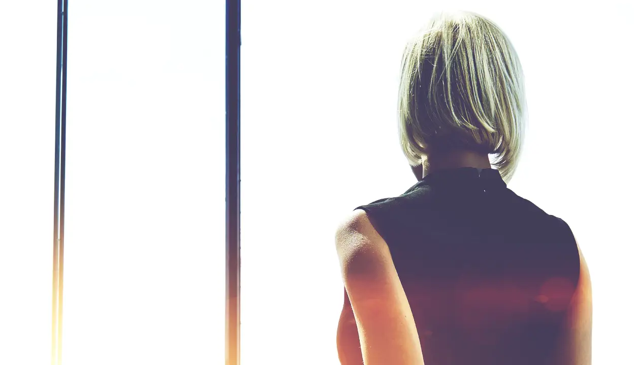 97cs - woman looking out of window - 1248x720