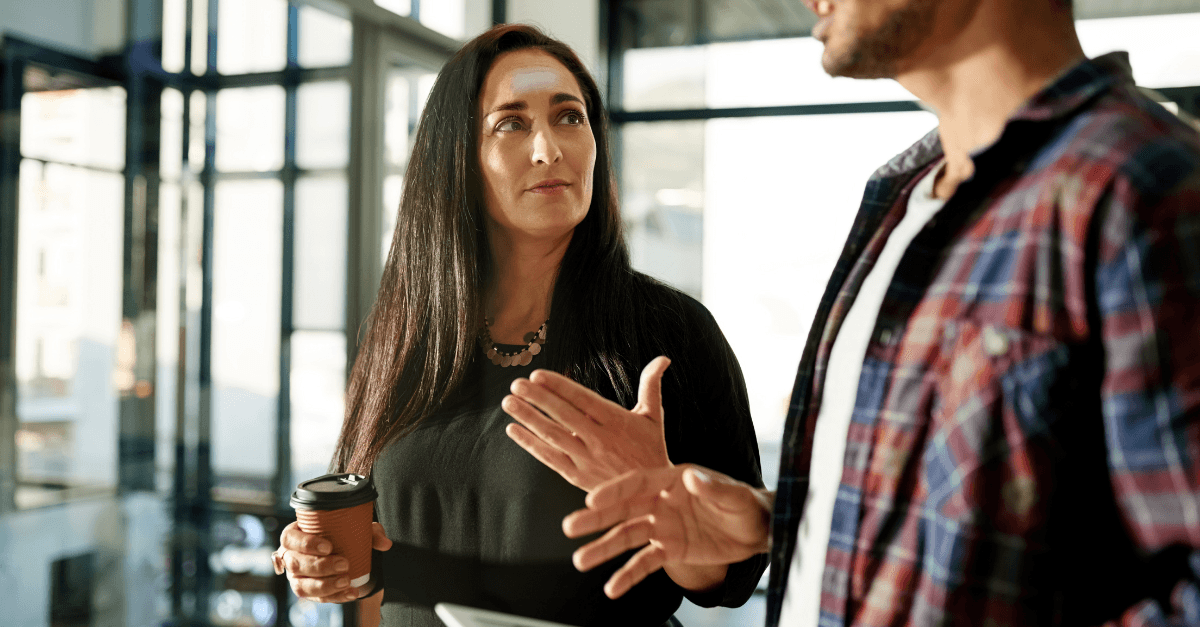 Man and Woman holding cup and gesticulating